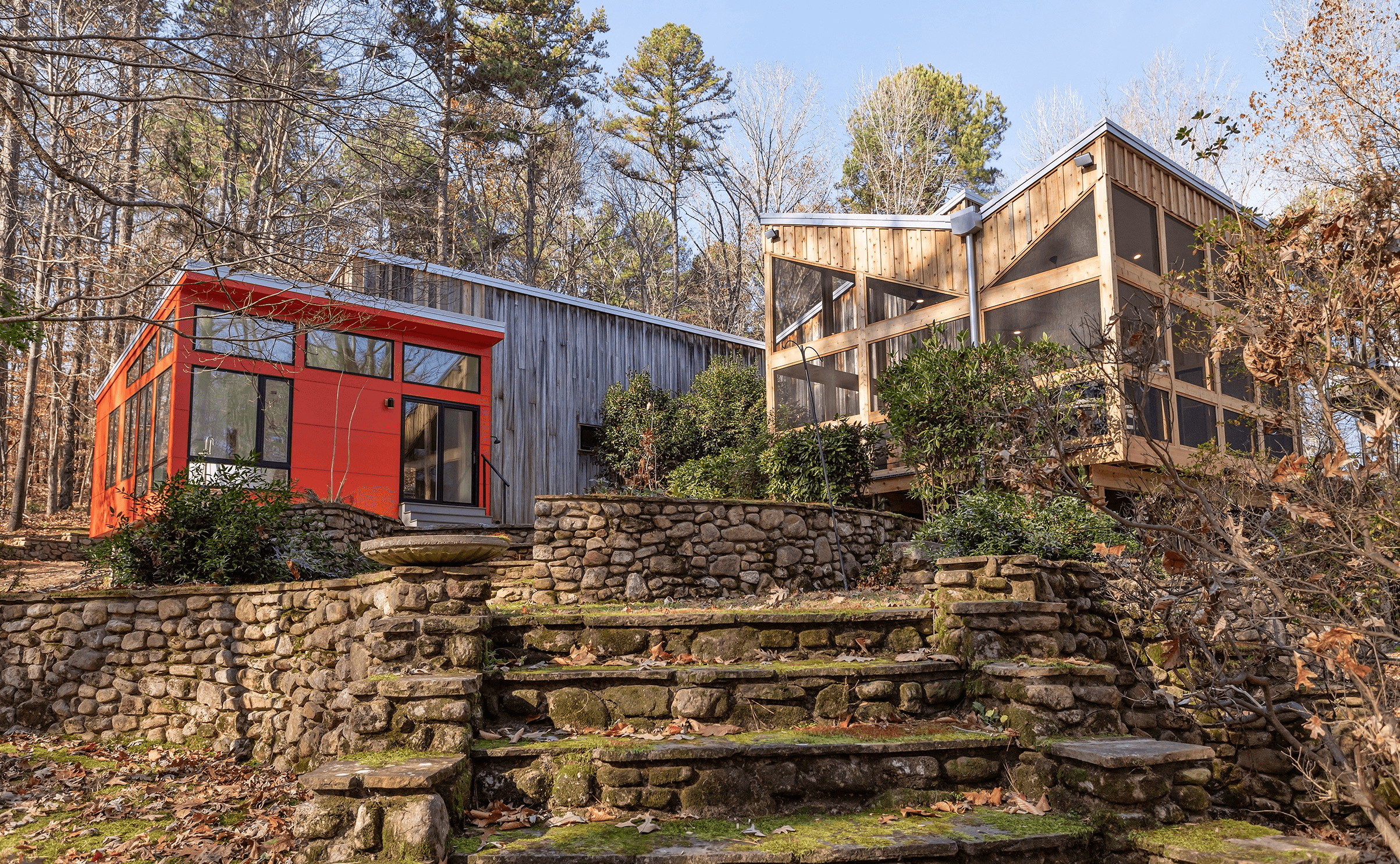 a house with a red door and steps leading up to it